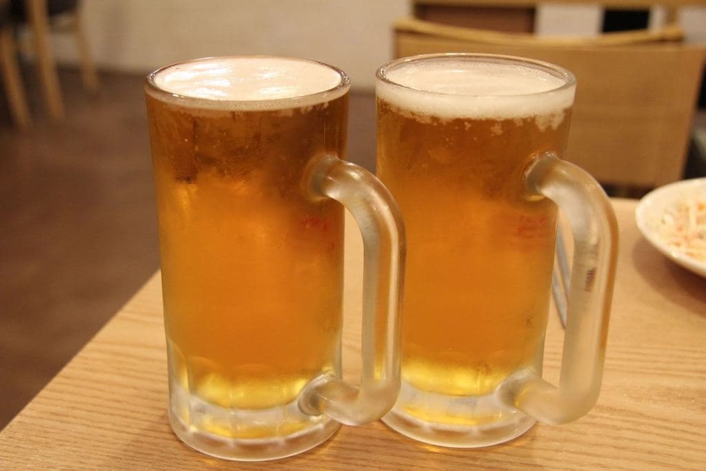 Two beer mugs on a restaurant table