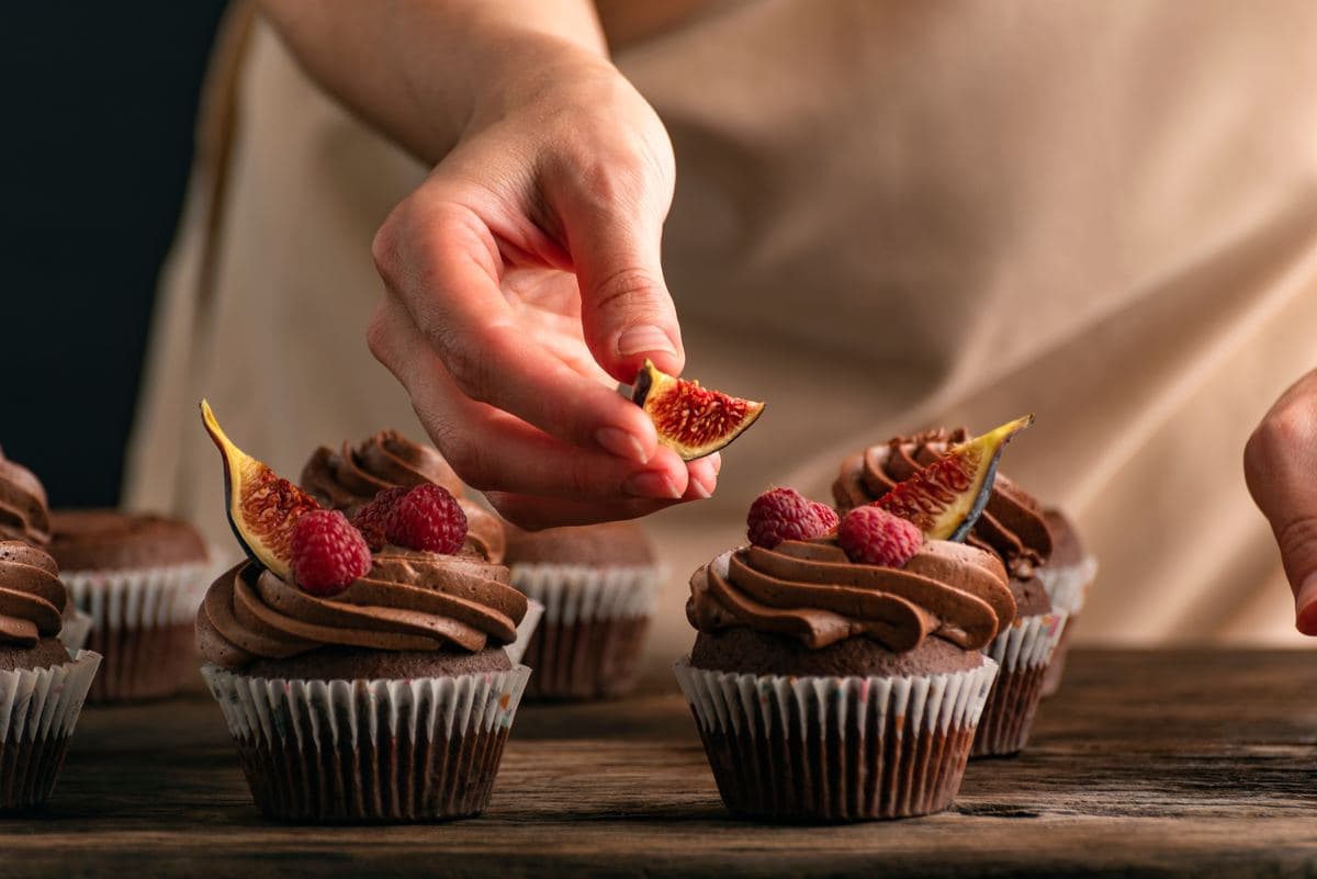 Cupcakes being finished by hand
