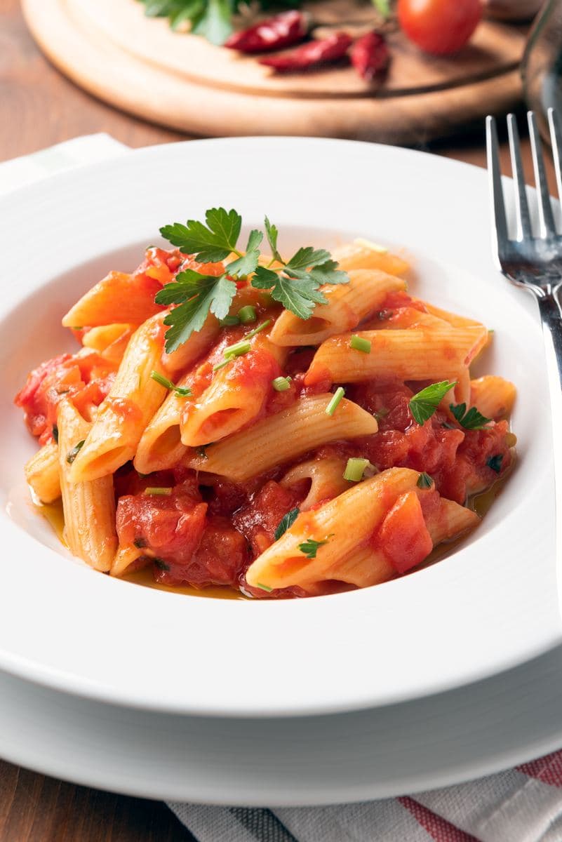 Penne pasta served in a white bowl