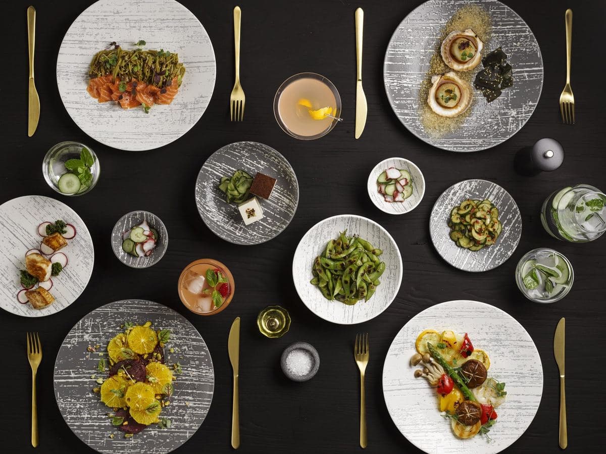 Plated dishes on Luzerne porcelain on a dark table