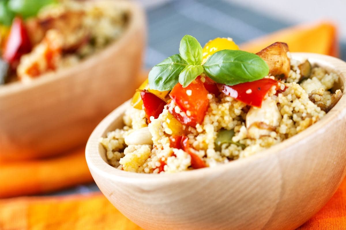 Couscous salad with roast vegetables in a wooden bowl