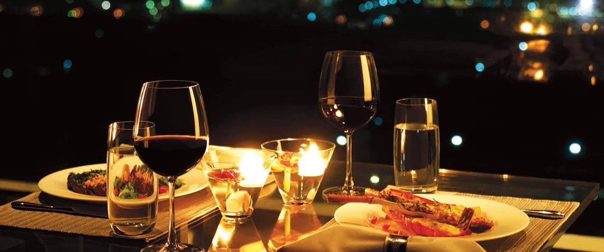 Ocean wine glasses on a candlelit dinner table