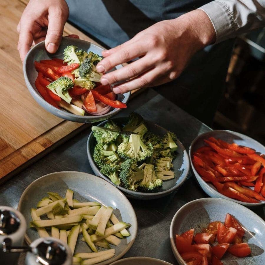 Sliced peppers, broccoli and courgette prepared in bowls