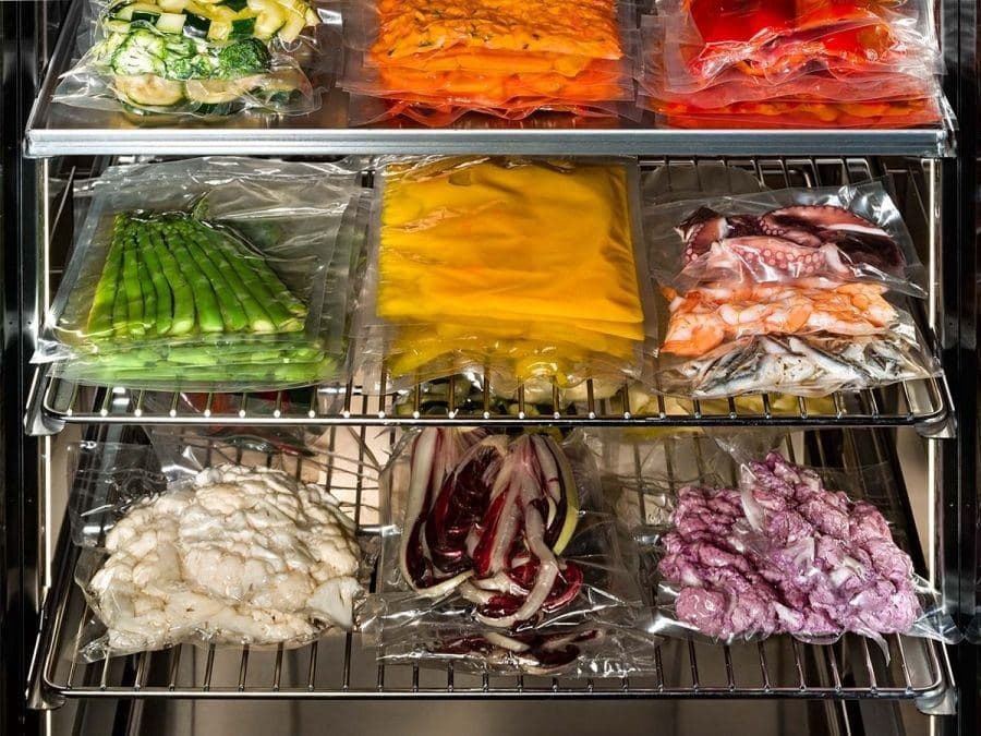 Vacuum-packed vegetables, seafood and purées on refrigerator shelves