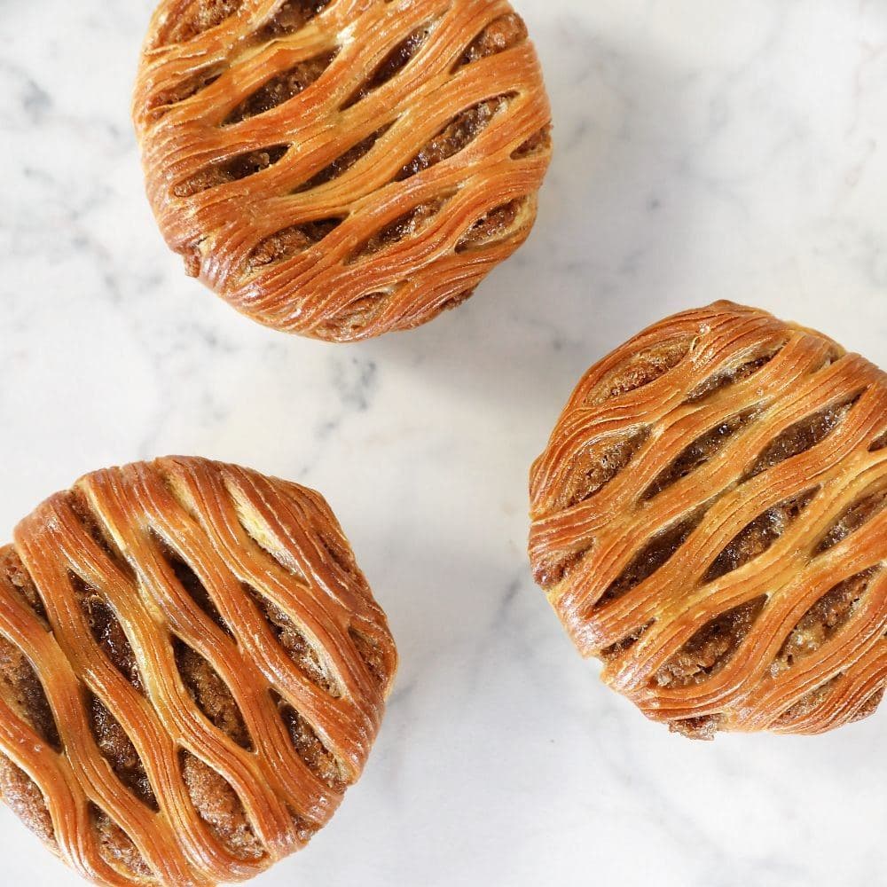 Lattice-crust pastries on a marble bench