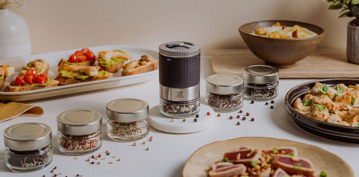 Peugeot mills and spice jars with plated food