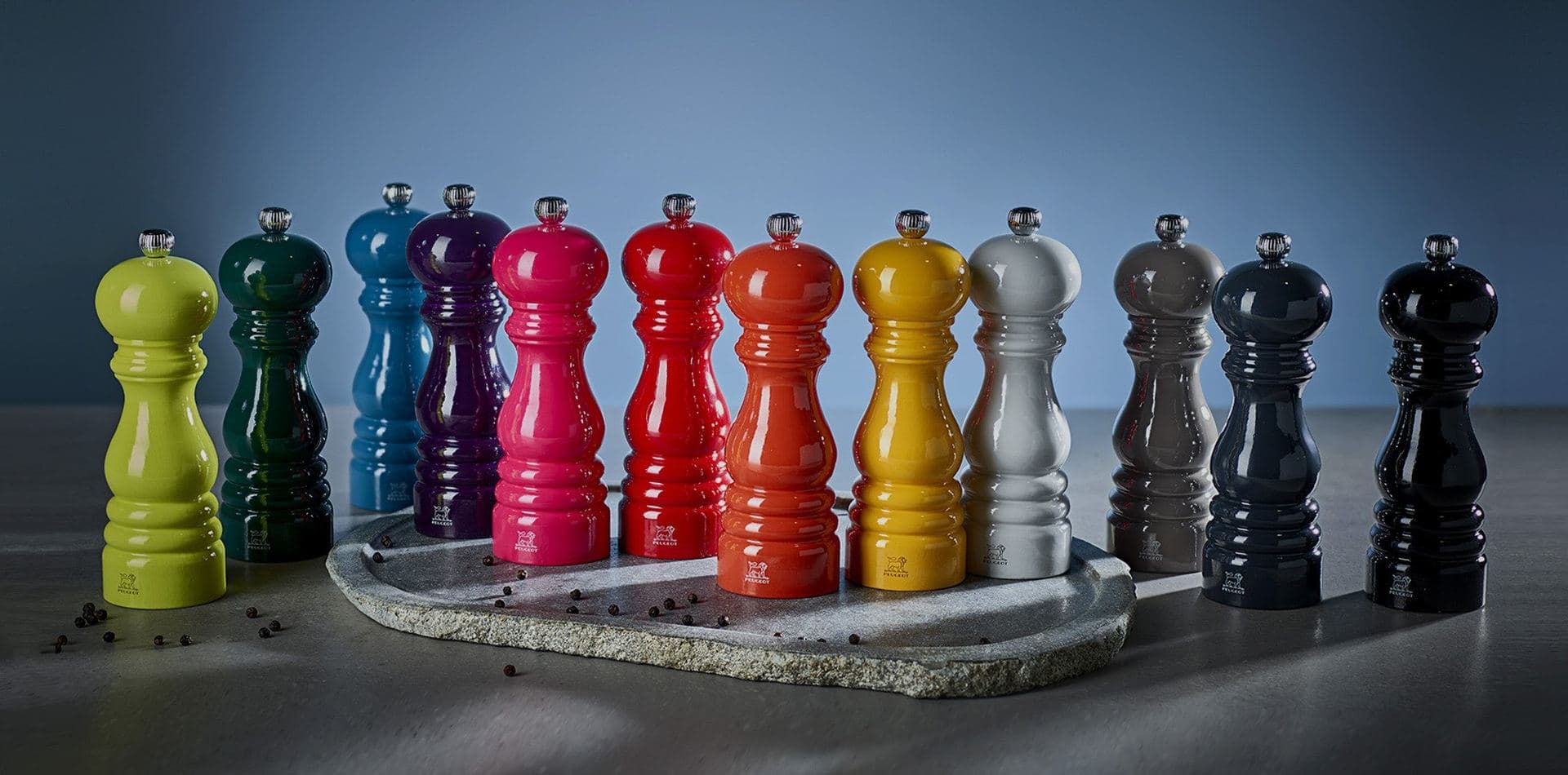A row of Peugeot salt and pepper mills in colours