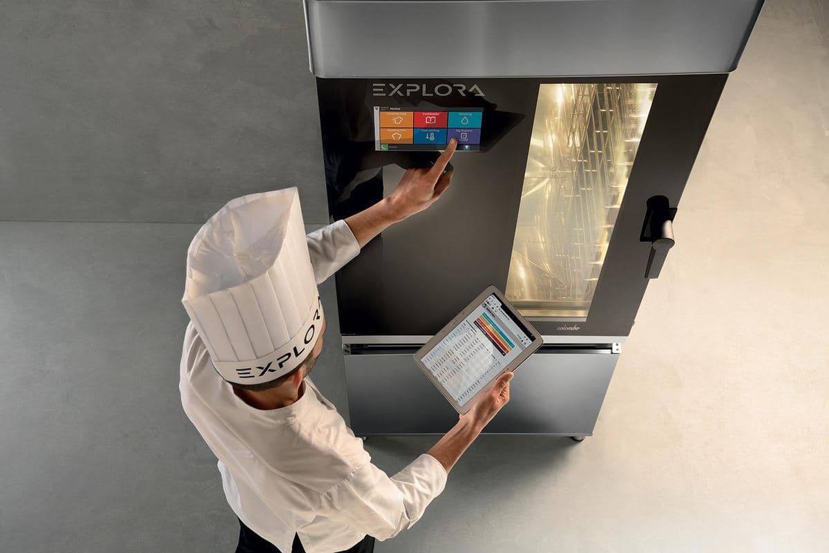 Chef setting a programme on an Explora combi oven's touchscreen