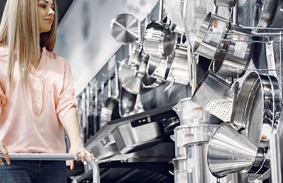 Pujadas stainless cookware hanging in a kitchen