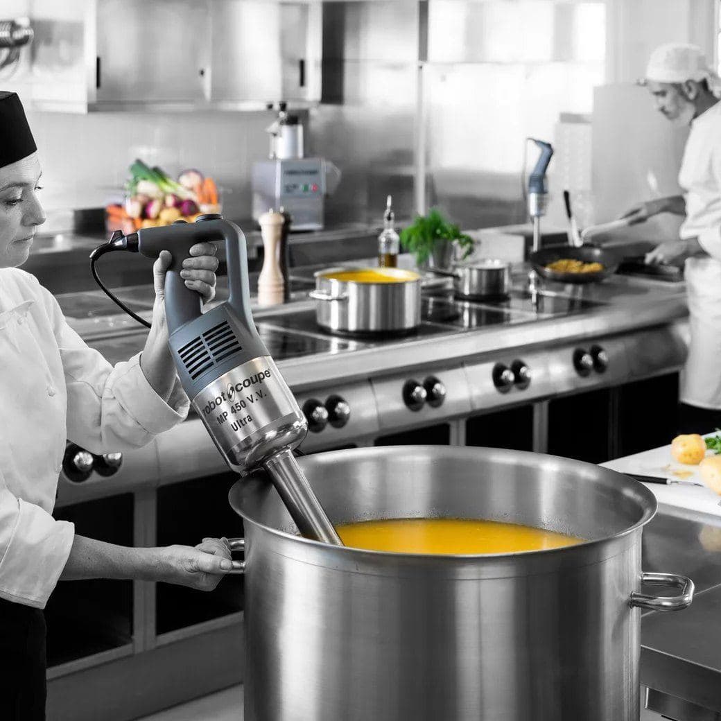 Chef using a Robot-Coupe power mixer in a stockpot