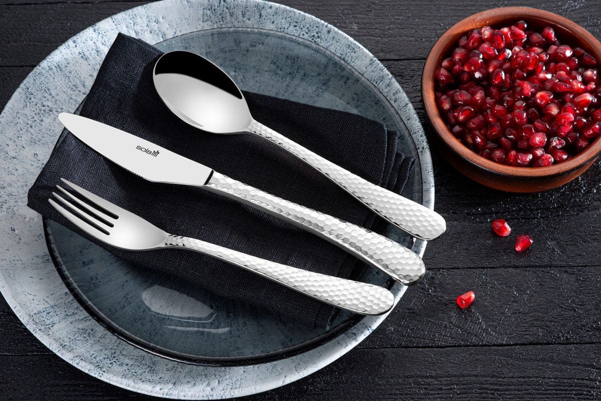 Sola knife, fork and spoon on a dark plate