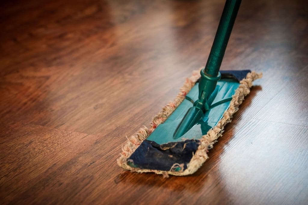 Flat mop cleaning a wooden floor